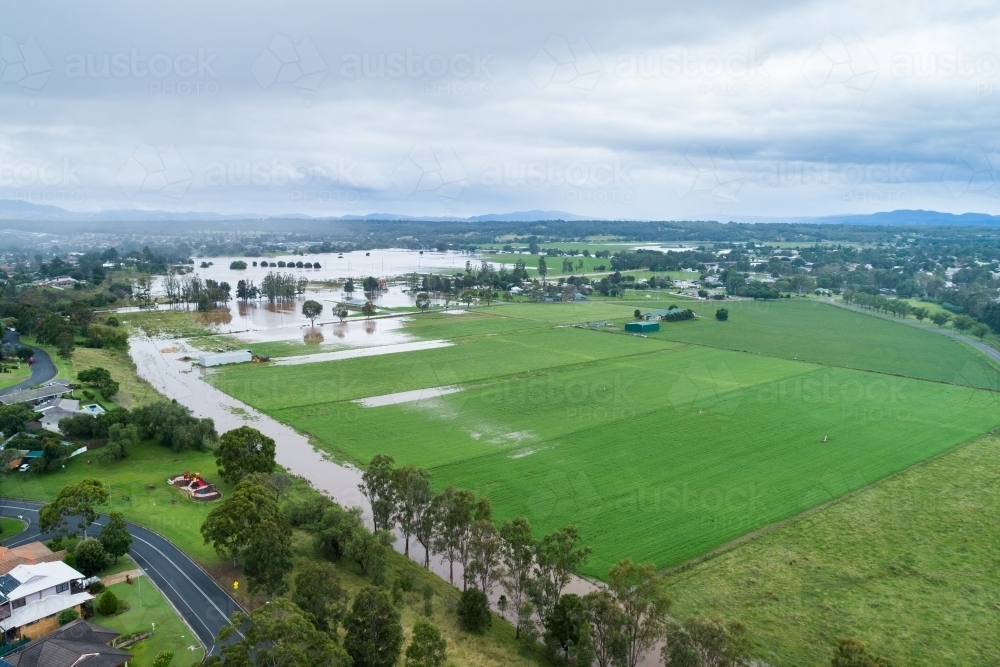 Incoming rain over flooding farmland in Hunter Valley - Australian Stock Image