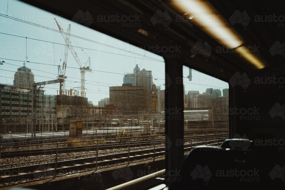 Industrial city view through a train window approaching central station - Australian Stock Image