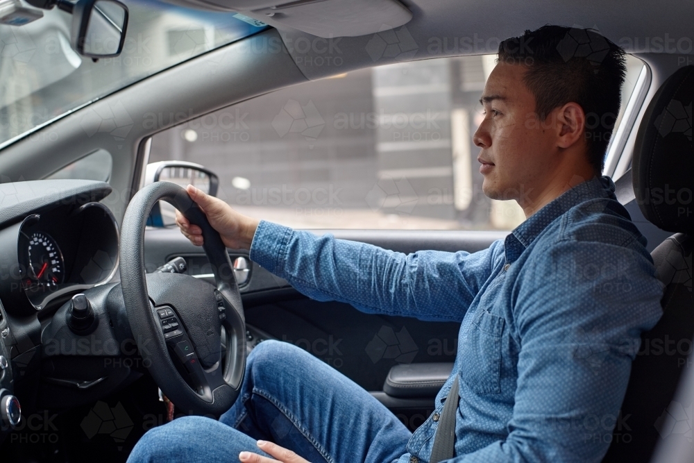 Interior of man driving car - Australian Stock Image