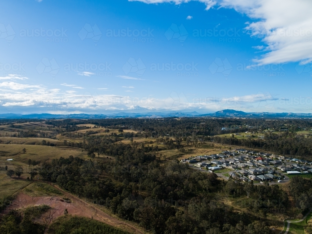 intersection of bush and built environment treed land with housing suburb encroaching - Australian Stock Image