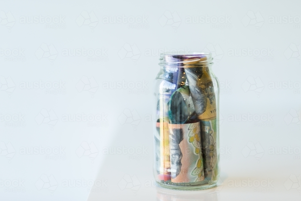 Jar of Australian currency notes and coins - Australian Stock Image