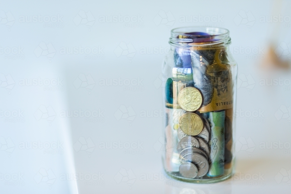 Jar of Australian currency notes and coins - Australian Stock Image