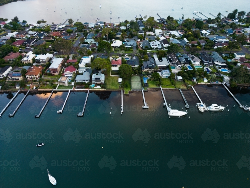 Jetties protruding from homes along the shore of Brisbane Water, Gosford - Australian Stock Image