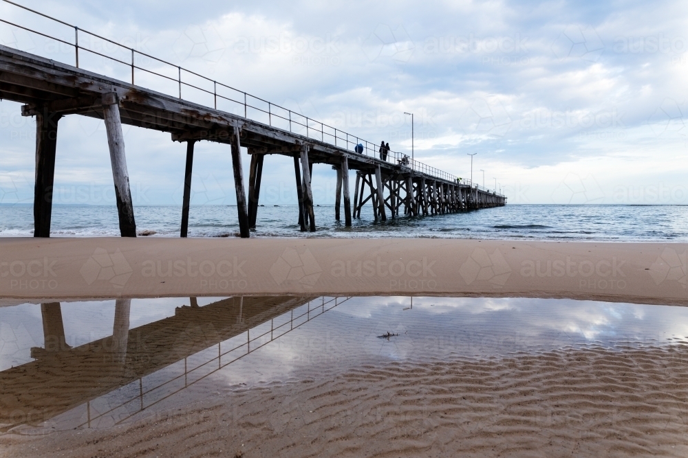 jetty and reflection on beach - Australian Stock Image