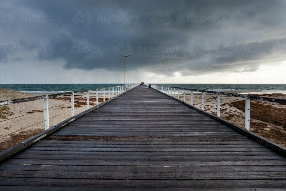 jetty under a stormy sky - Australian Stock Image