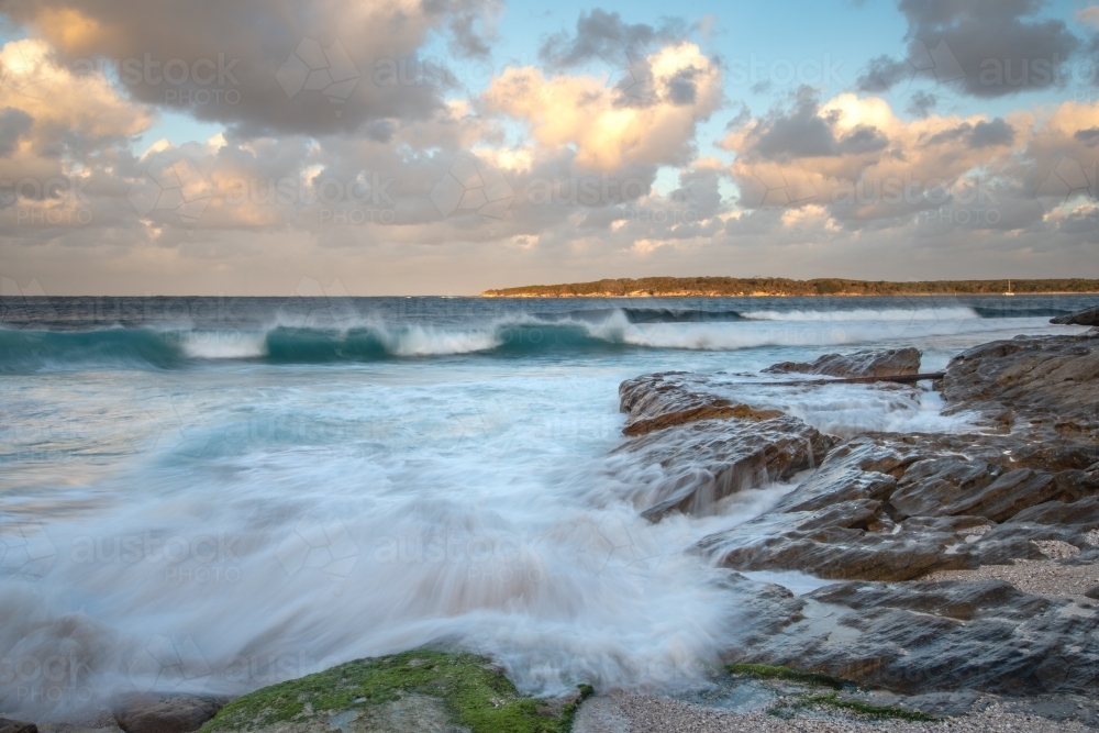 Jibbon Head at sunset with blurred waves in the foreground - Australian Stock Image