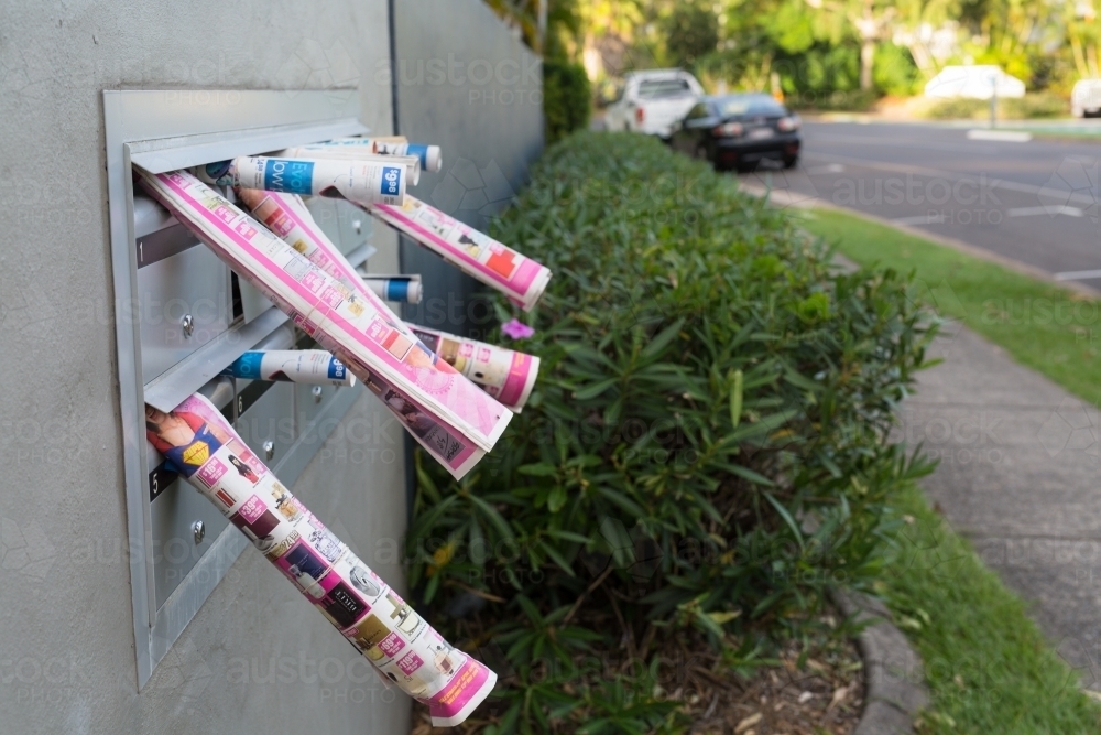 Junk mail sticking out of letter boxes - Australian Stock Image