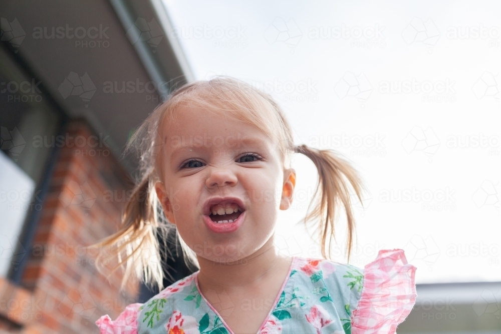 Kid pulling silly smile face - Australian Stock Image