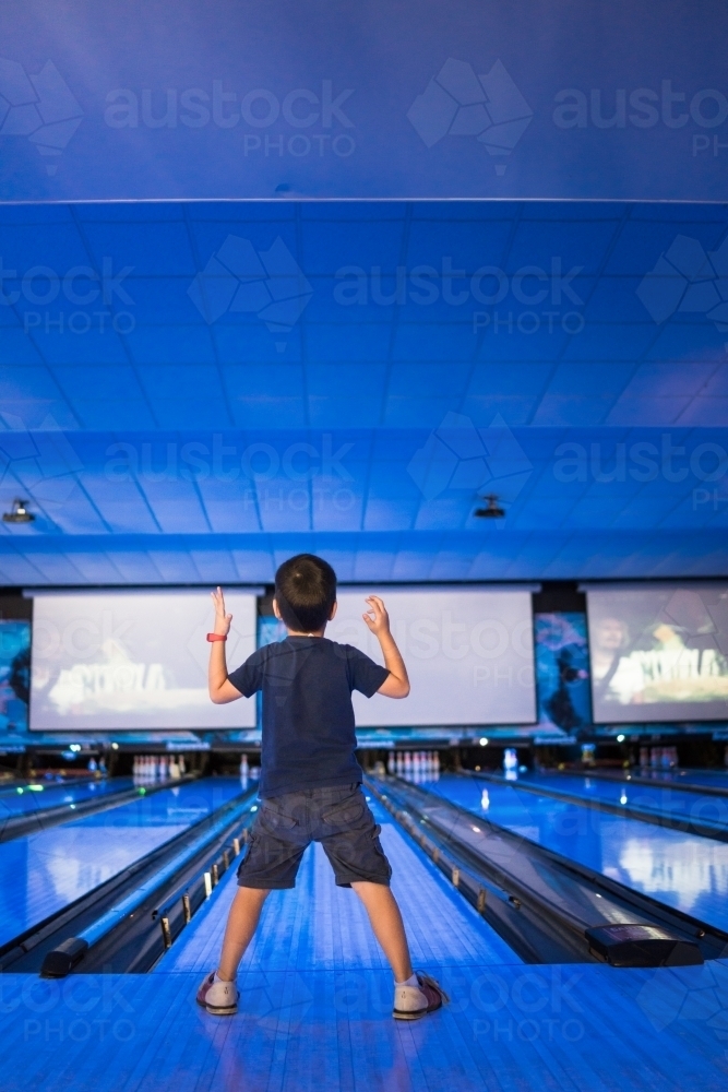 Kids 10 pin bowling under blue lights - Australian Stock Image