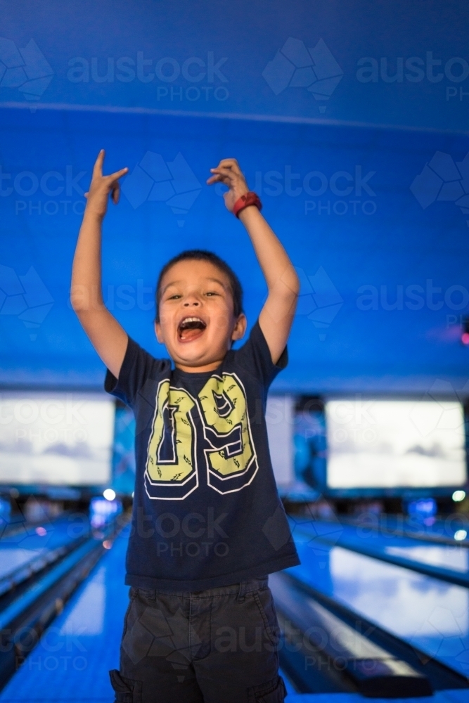 Kids 10 pin bowling under blue lights - Australian Stock Image