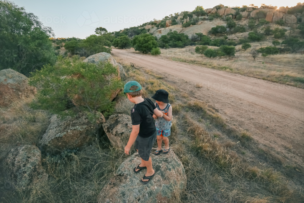 Kids climbing on rocks on outdoor adventure at Mt Hope in Central Victoria - Australian Stock Image