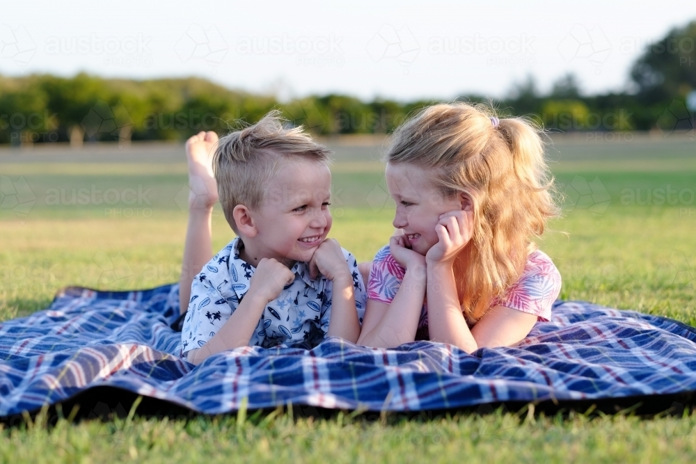 Kids enjoying the afternoon sunshine in the park - Australian Stock Image