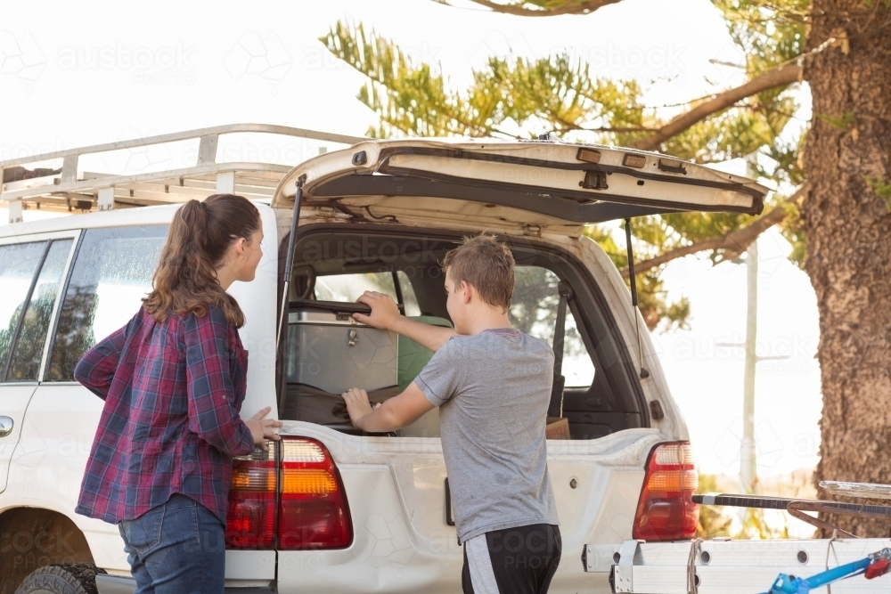 Kids getting stuff out of 4WD vehicle - Australian Stock Image