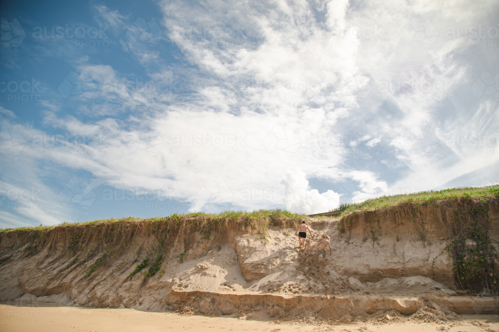 Kids playing on the sand dunes at the beach, Coffs Harbour Australia - Australian Stock Image