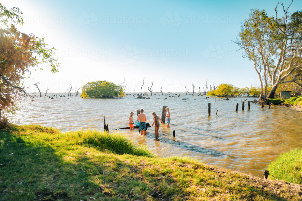 Kids swimming at Kow Swamp in rural Victoria - Australian Stock Image