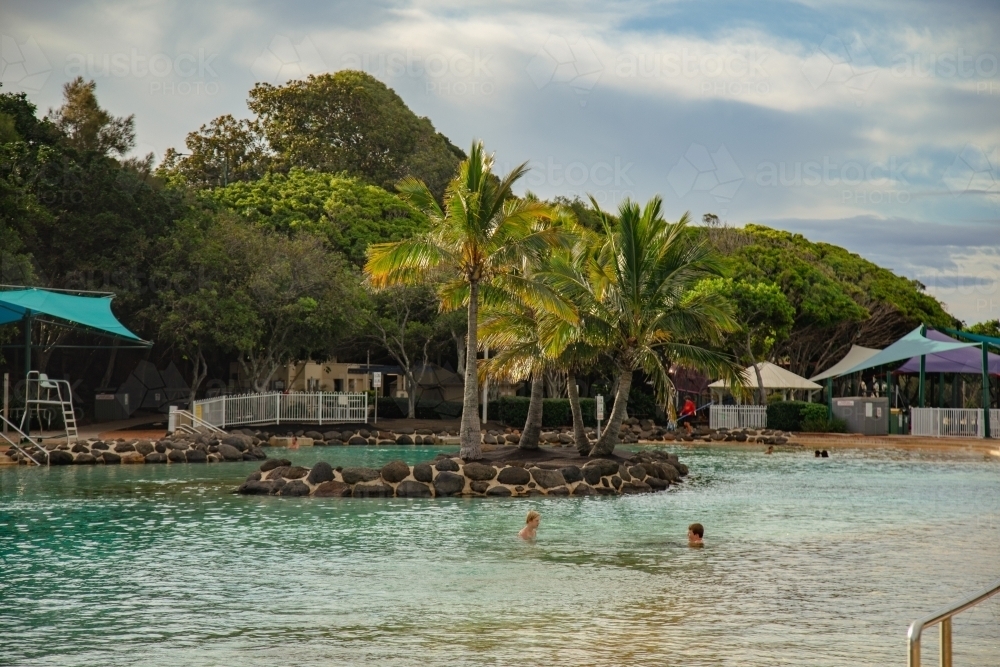 Kids swimming at the Settlement Cove Lagoon swimming pool in Redcliffe, Queensland Australia - Australian Stock Image