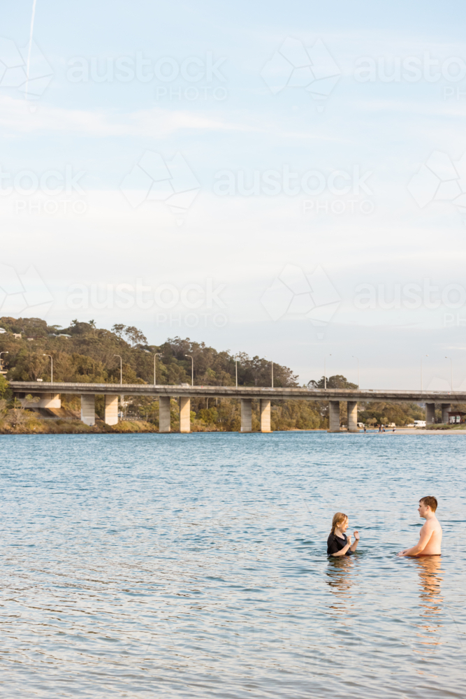 Kids swimming in the Currumbin Creek at Palm Beach in Queensland - Australian Stock Image