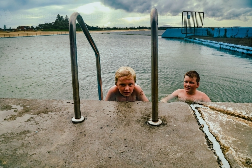 Kids swimming in the Ocean Baths swimming pool at Forster, New South Wales Australia - Australian Stock Image