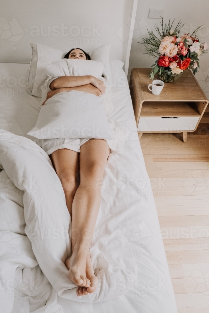 Lady in bed thinking. - Australian Stock Image