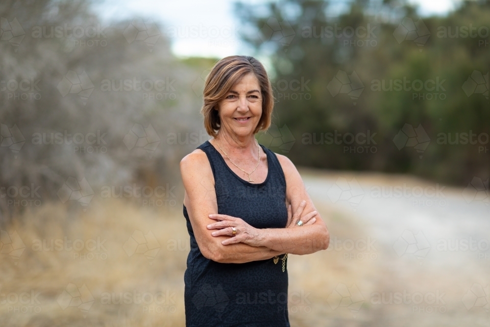 lady in black with crossed arms looking at camera - Australian Stock Image