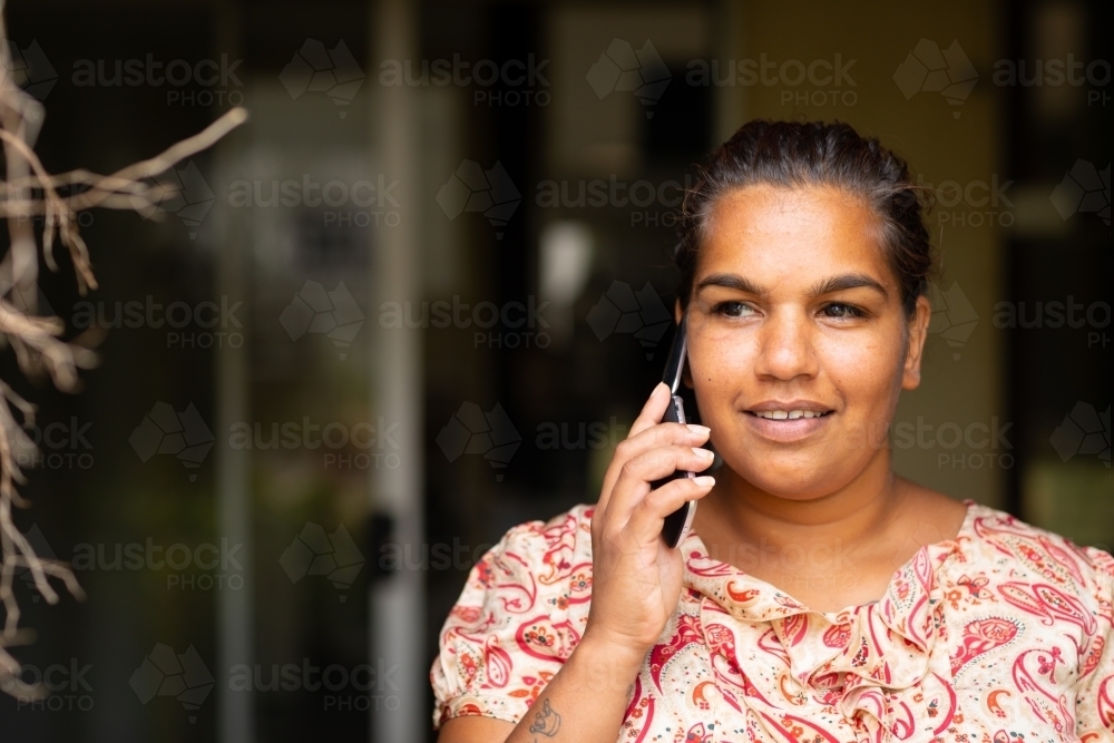 lady talking on old-fashioned  flip phone - Australian Stock Image