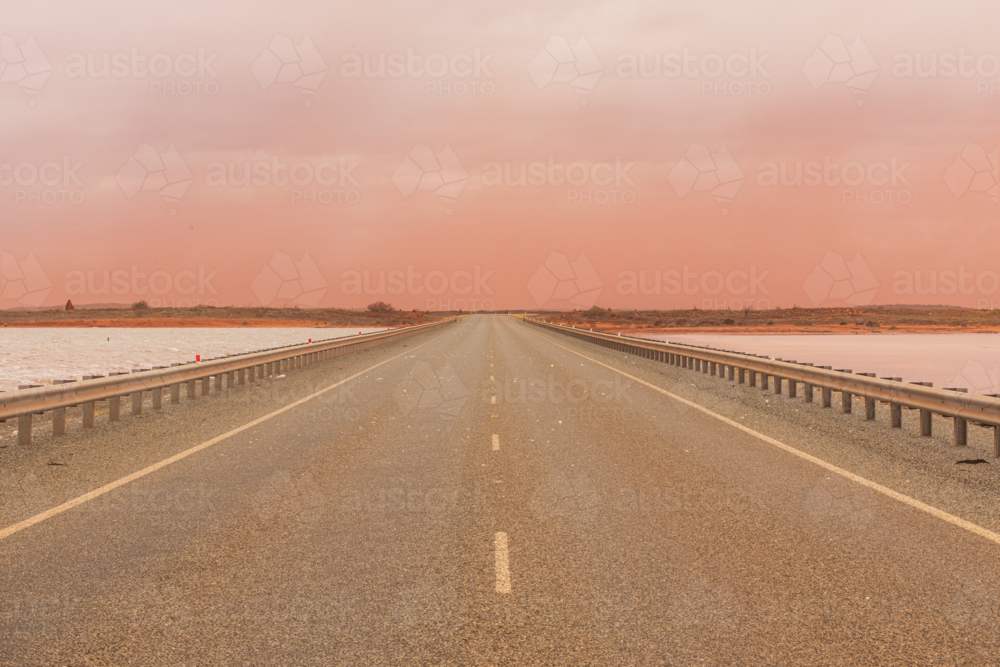 Landscape image of Onslow road in a dust storm. with salt lakes either side - Australian Stock Image