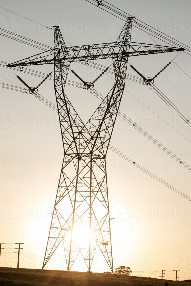 landscape of powerlines with sunset behind - Australian Stock Image