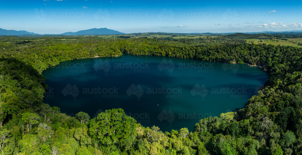 landscape of rainforest and deep blue lake - Australian Stock Image