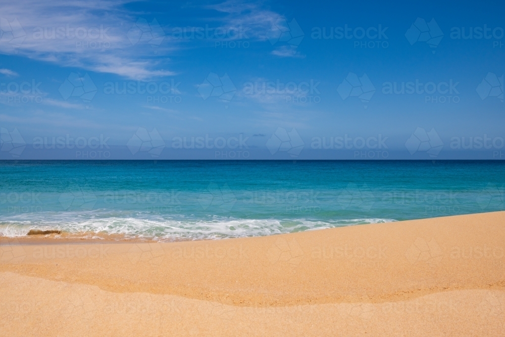 Landscape view of sand and ocean, and blue sky - Australian Stock Image