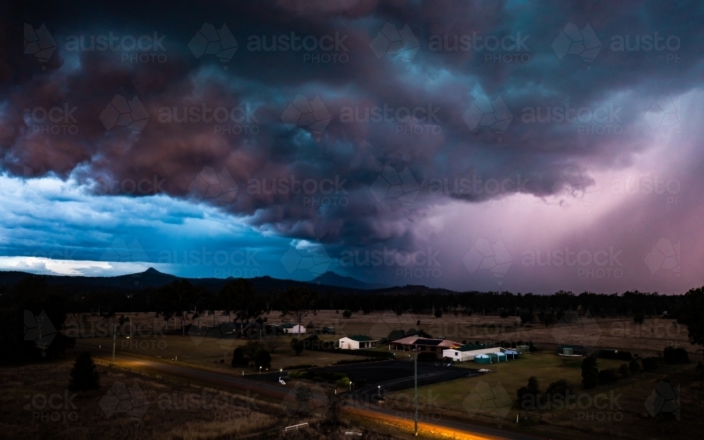 Landscape with dramatic storm clouds at sunset - Australian Stock Image
