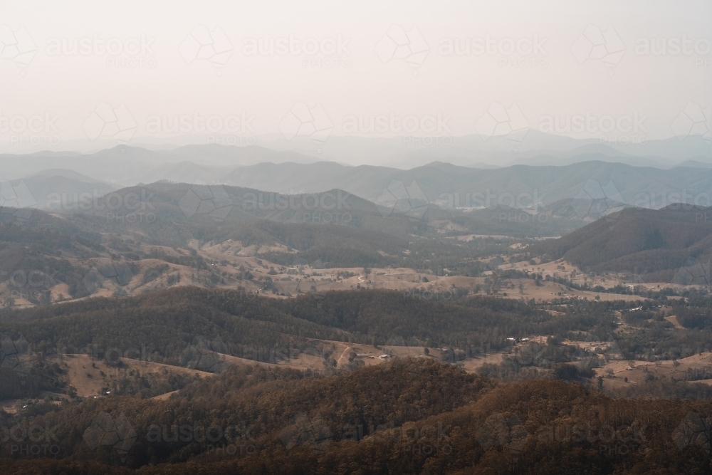 Landscape with hazy mountain views behind a valley in regional New South Wales. - Australian Stock Image