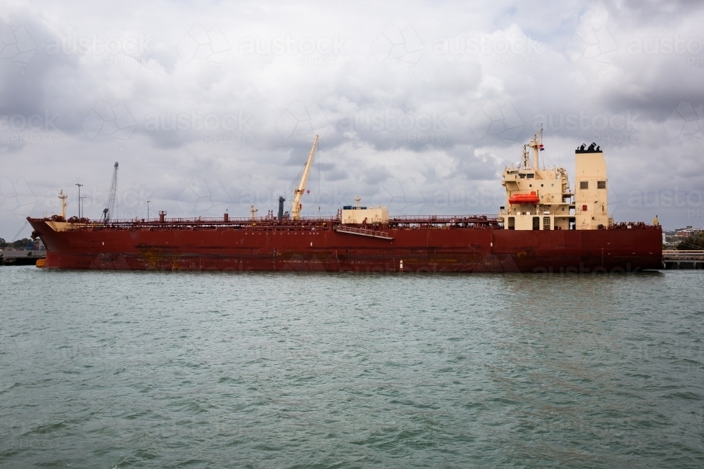 large dark red ship docked in Gladstone harbour - Australian Stock Image