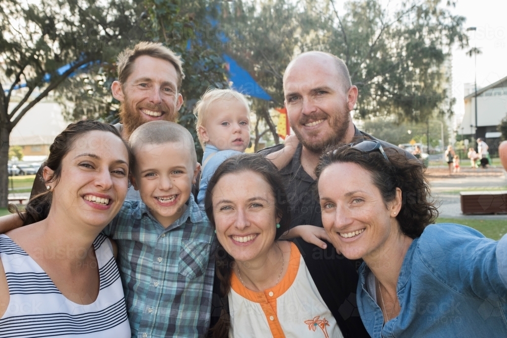 Large group of friends and family taking a photo of themselves in the park - Australian Stock Image