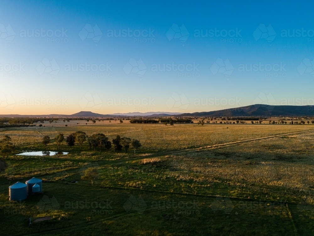 Last light of the day over australian farm paddock seen from aerial view - Australian Stock Image