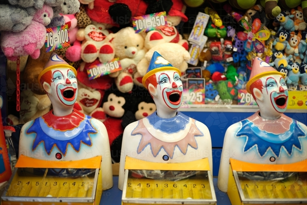 Laughing clowns game at fairground booth - Australian Stock Image