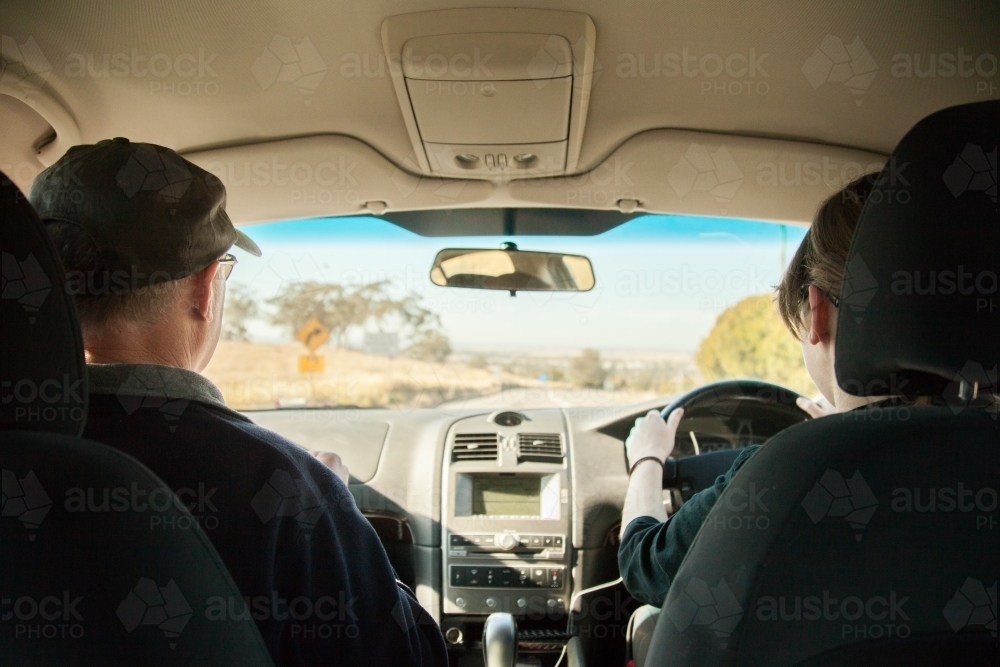 Learner driver getting driving experience with father instructing her - Australian Stock Image