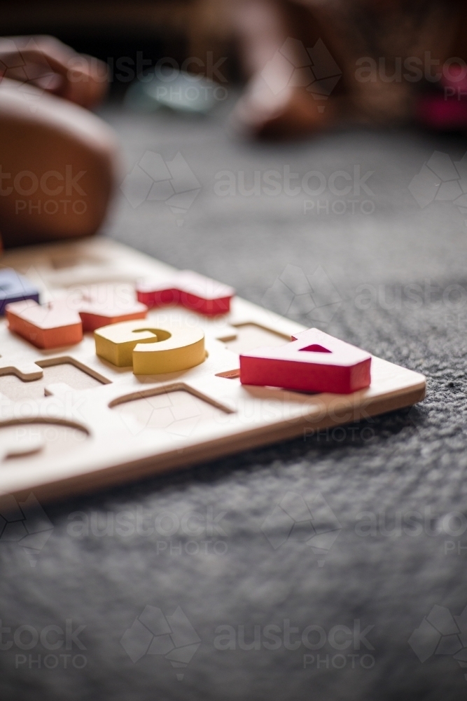 Letter A of alphabet puzzle educational toy on preschool floor - Australian Stock Image