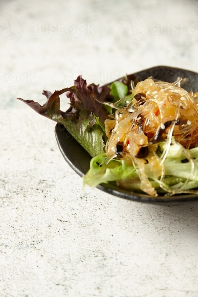 lettuce with clear noodles and sesame seeds - Australian Stock Image