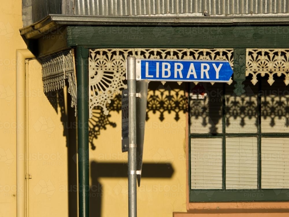 "Library" sign in front of an old building with iron lace decoration - Australian Stock Image