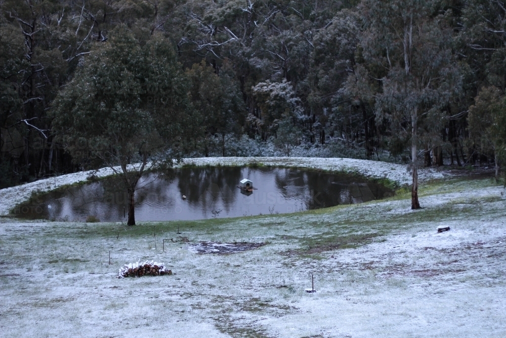 Light snow coverage around dam - Australian Stock Image