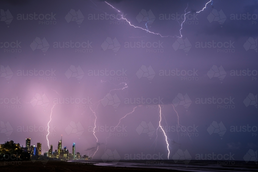 Lightning bolts across the night sky against the Gold Coast cityscape - Australian Stock Image