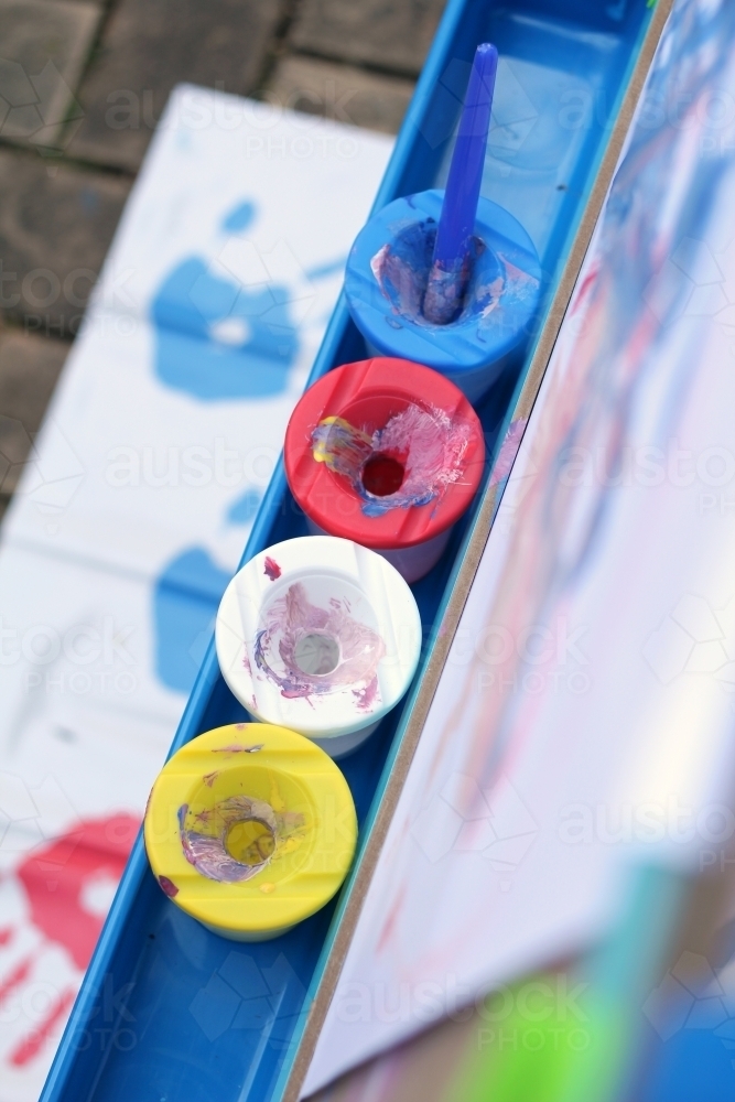 Line of paint pots on easel - Australian Stock Image