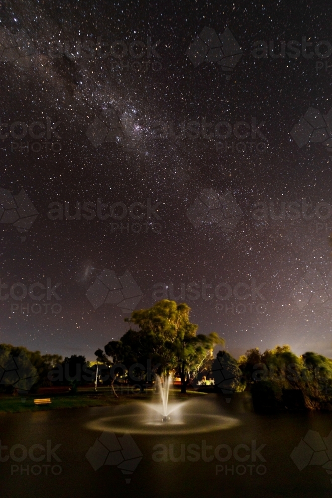 lit up fountain under starry sky - Australian Stock Image