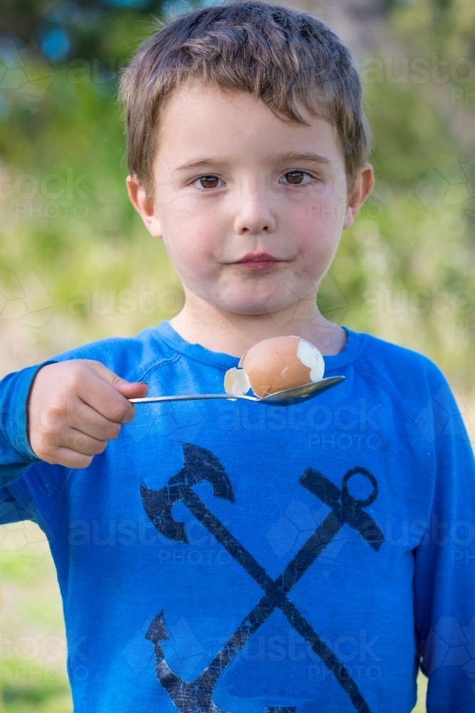 Little boy ready for egg and spoon race. - Australian Stock Image