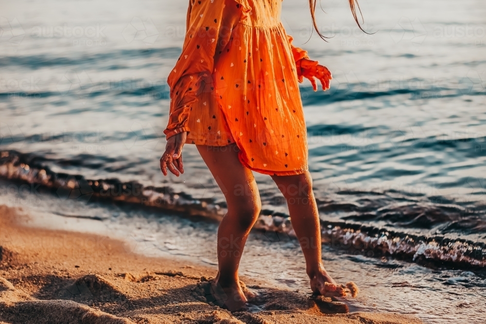 Little girl at the beach and waves - Australian Stock Image