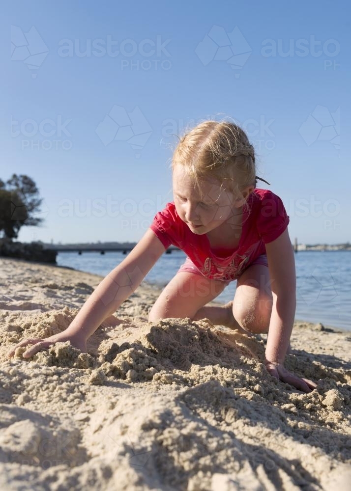 Little Girl Digging In The Sand - Australian Stock Image