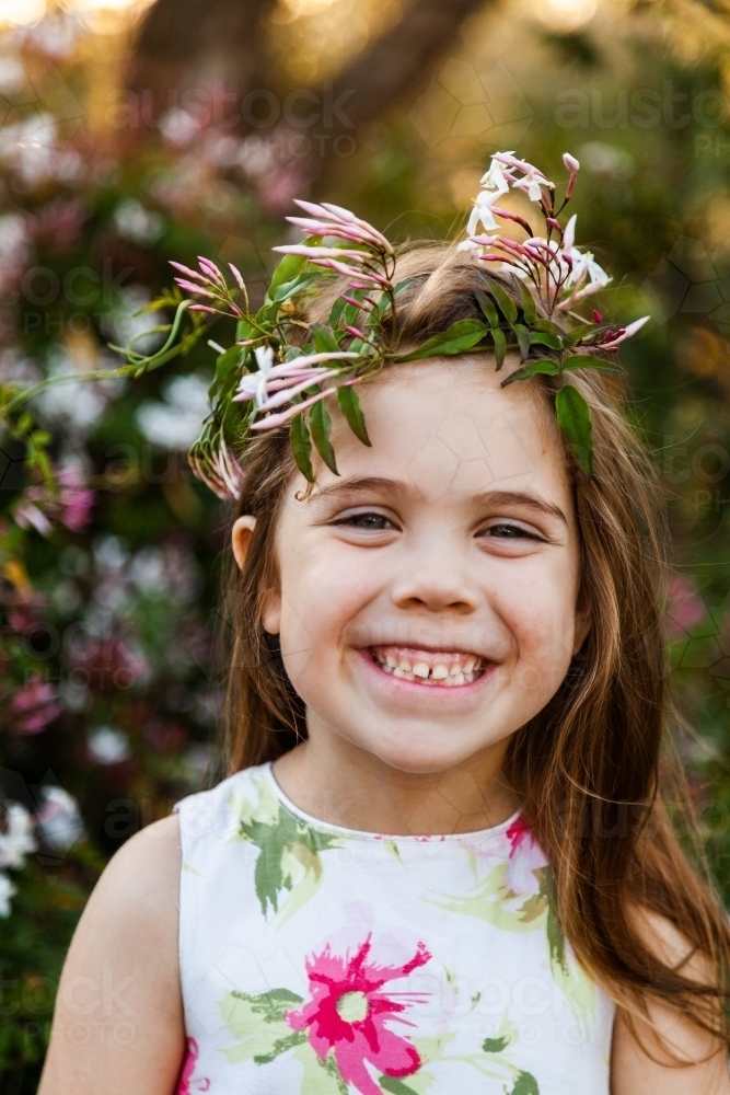 Little girl in garden with jasmine flower crown - Australian Stock Image