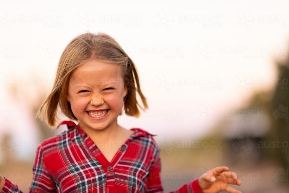 little girl making scary monster face - Australian Stock Image