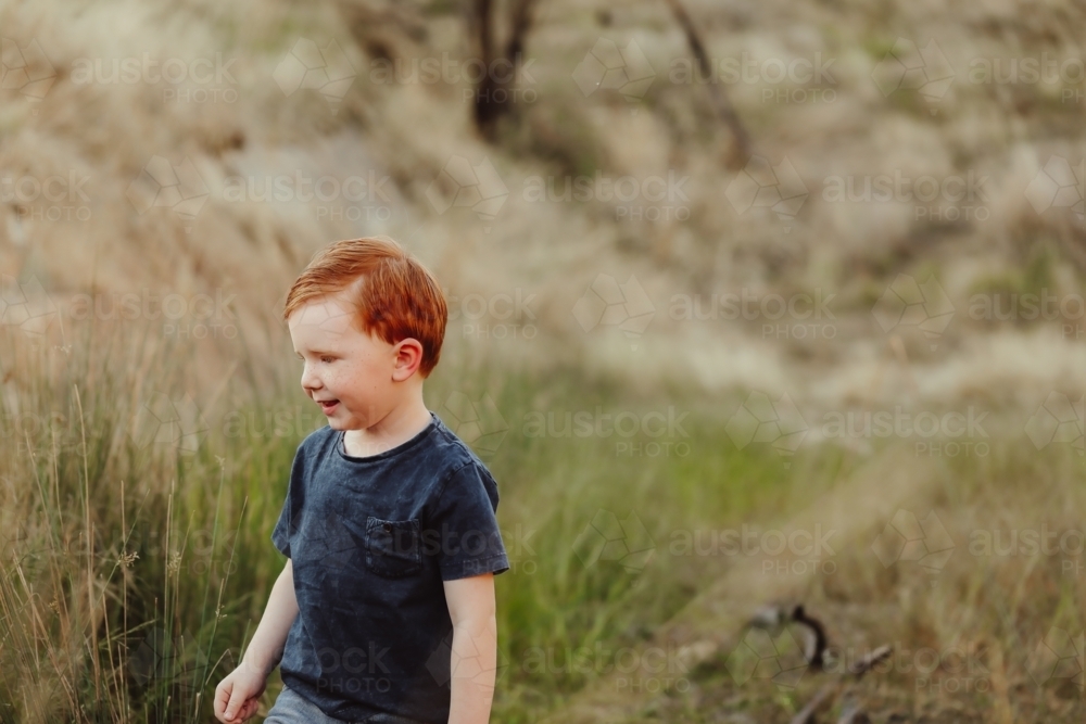 Little red head boy exploring in the Australian bush - Australian Stock Image