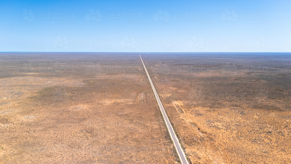 Long straight road on a vast barren land. - Australian Stock Image